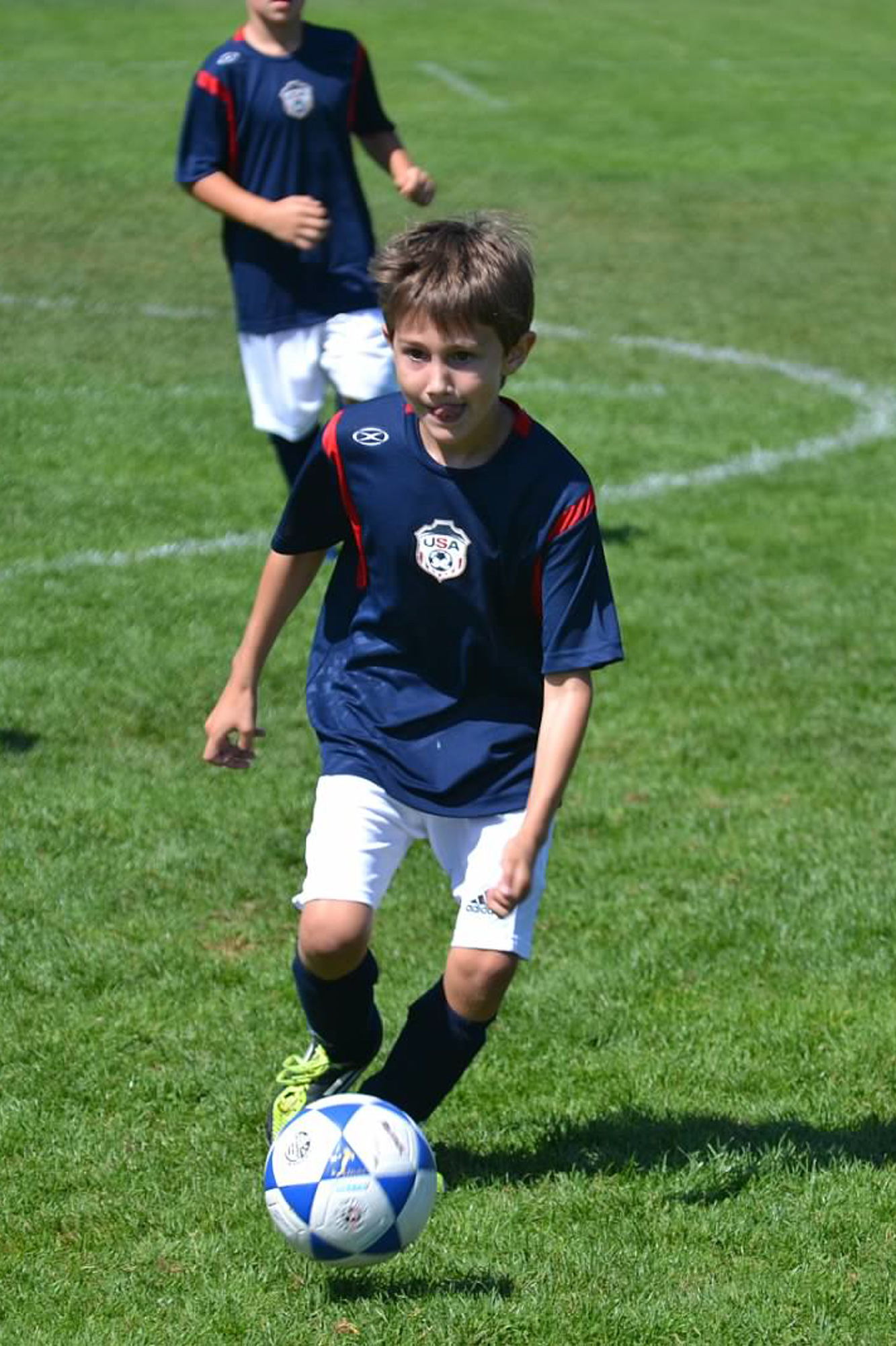 boy dribbling ball